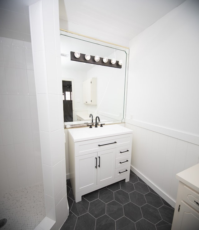 2718 Central Ave, Big Spring, TX 79720 - full bathroom featuring vanity, wainscoting, tile patterned flooring, and a walk in shower