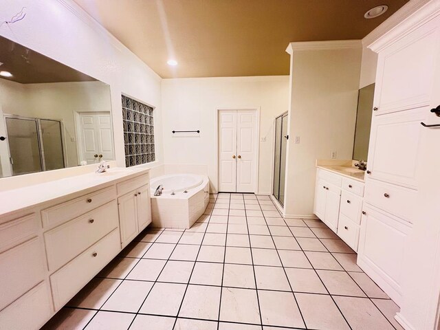 bathroom featuring tile patterned flooring, vanity, and separate shower and tub