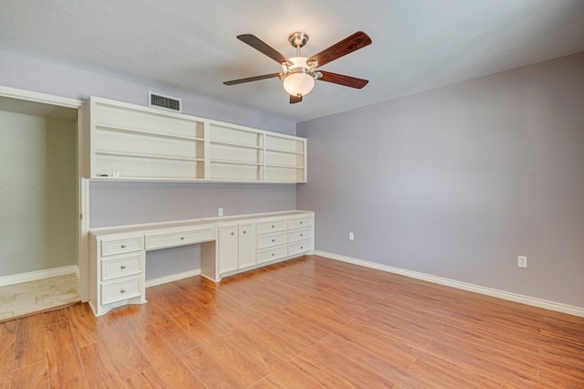 2601 Dengar Ave W, Midland, TX 79705 - unfurnished office with built in desk, a ceiling fan, light wood-style flooring, and baseboards