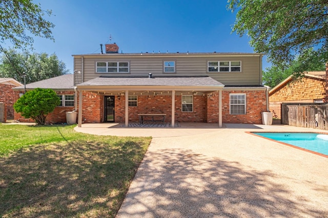2601 Dengar Ave W, Midland, TX 79705 - rear view of property featuring a patio, brick siding, a chimney, and roof with shingles