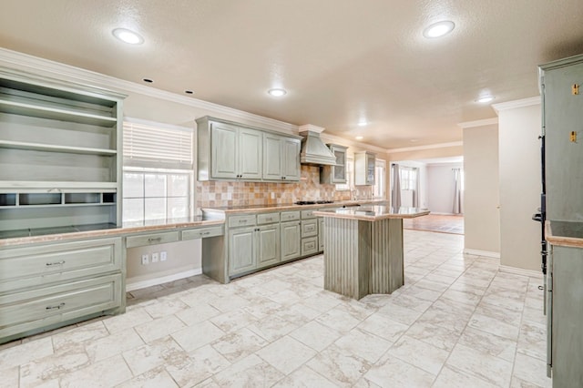 2601 Dengar Ave W, Midland, TX 79705 - kitchen with custom range hood, gray cabinetry, a kitchen island, black gas cooktop, and light countertops