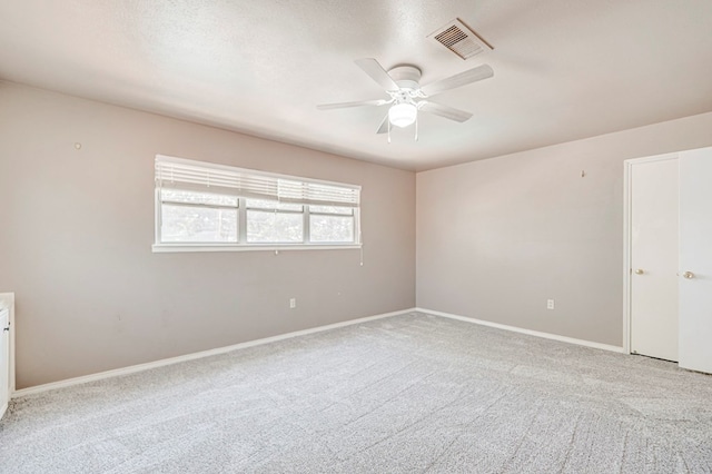 2601 Dengar Ave W, Midland, TX 79705 - spare room with light colored carpet, ceiling fan, and baseboards
