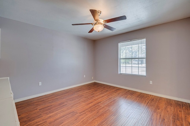 2601 Dengar Ave W, Midland, TX 79705 - spare room featuring wood finished floors, baseboards, and a ceiling fan