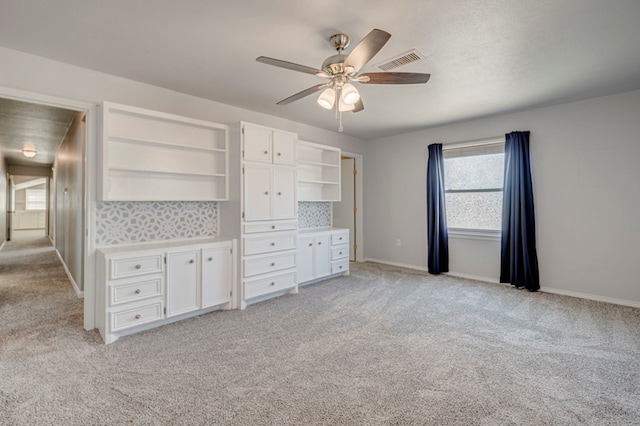 2601 Dengar Ave W, Midland, TX 79705 - unfurnished bedroom with light carpet, baseboards, and a ceiling fan