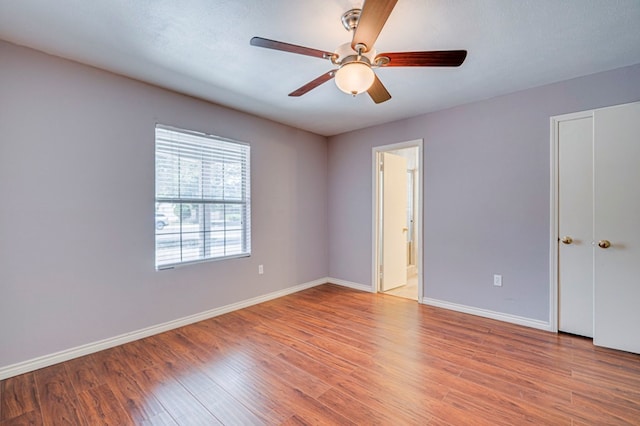 2601 Dengar Ave W, Midland, TX 79705 - unfurnished bedroom featuring baseboards, light wood-type flooring, ceiling fan, and ensuite bath