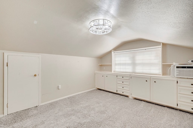 2601 Dengar Ave W, Midland, TX 79705 - additional living space featuring vaulted ceiling, light colored carpet, a textured ceiling, and baseboards