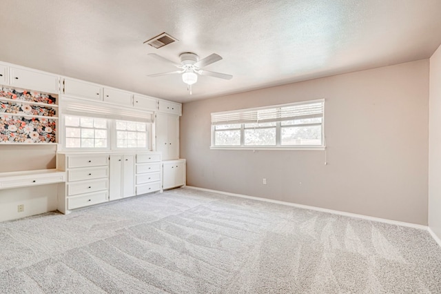 2601 Dengar Ave W, Midland, TX 79705 - unfurnished bedroom featuring light colored carpet, baseboards, and ceiling fan