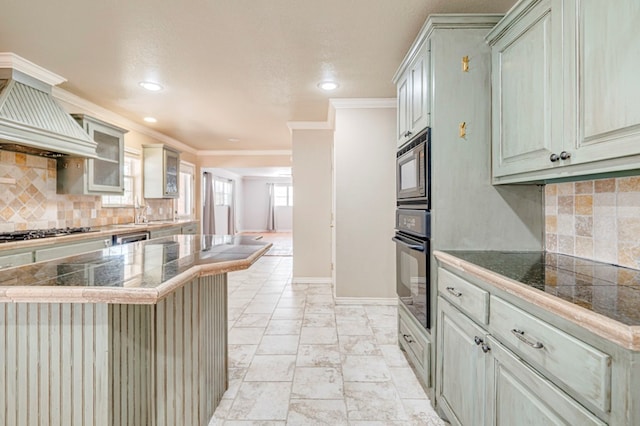2601 Dengar Ave W, Midland, TX 79705 - kitchen with appliances with stainless steel finishes, tile counters, custom range hood, tasteful backsplash, and crown molding