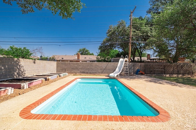 2601 Dengar Ave W, Midland, TX 79705 - view of pool with a water slide, a fenced backyard, and a patio