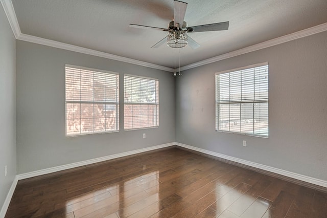 2601 Dengar Ave W, Midland, TX 79705 - empty room with dark wood-type flooring, healthy amount of natural light, crown molding, ceiling fan, and baseboards