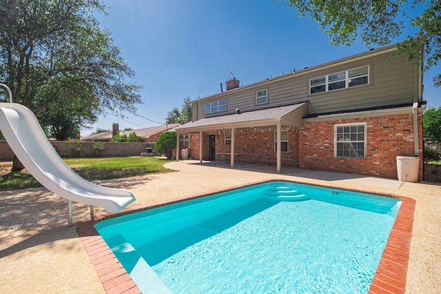 2601 Dengar Ave W, Midland, TX 79705 - view of swimming pool with a water slide, a patio, and a fenced backyard