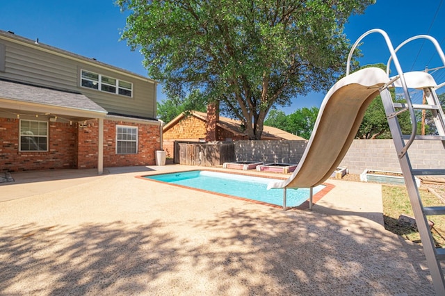 2601 Dengar Ave W, Midland, TX 79705 - view of swimming pool featuring a water slide, a patio, and a fenced backyard