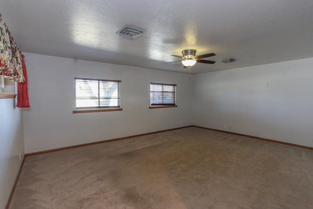 carpeted empty room with ceiling fan