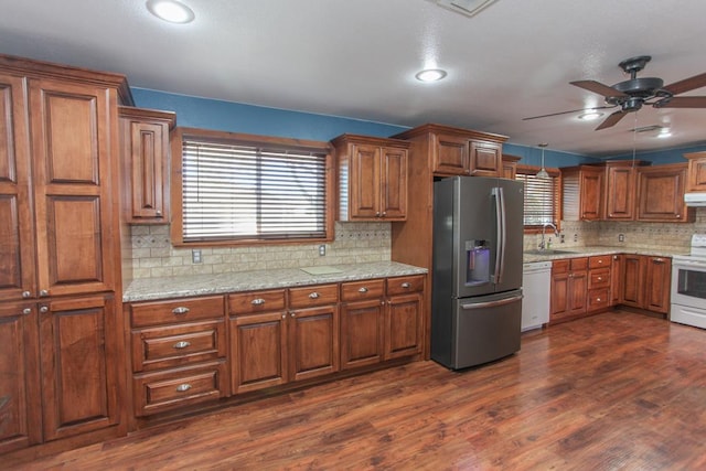 kitchen featuring pendant lighting, white appliances, dark wood-type flooring, sink, and ceiling fan