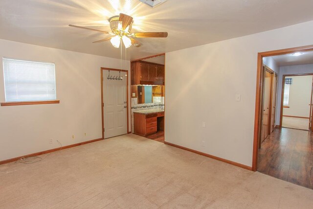 carpeted empty room with ceiling fan