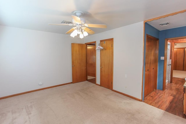 unfurnished bedroom with carpet flooring and ceiling fan