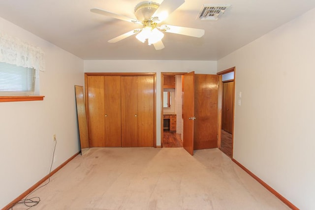 unfurnished bedroom featuring light carpet, a closet, and ceiling fan