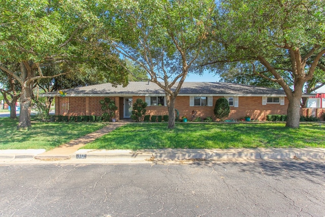 ranch-style home with a front lawn