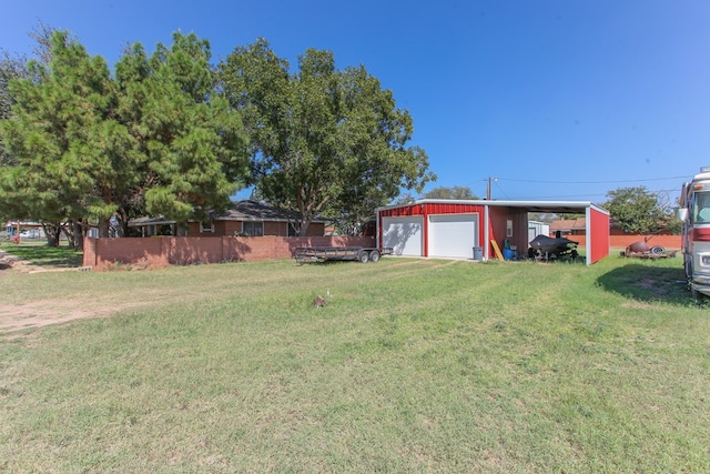 view of yard with a carport, a garage, and an outdoor structure