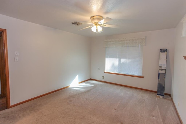 carpeted empty room featuring ceiling fan