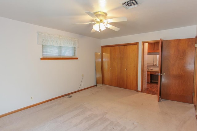 unfurnished bedroom featuring ceiling fan and carpet floors