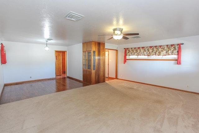 carpeted spare room with ceiling fan