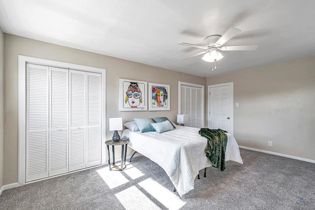 carpeted bedroom featuring ceiling fan, baseboards, and two closets