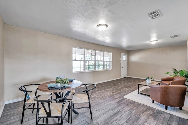 interior space featuring baseboards, visible vents, and wood finished floors