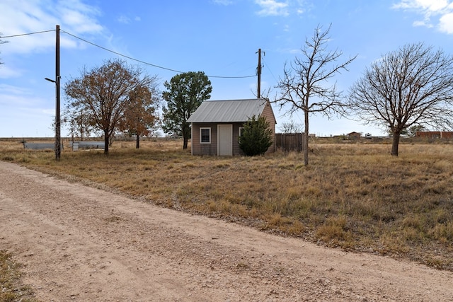 exterior space featuring a rural view and an outbuilding