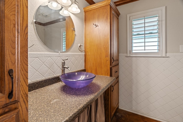 bathroom featuring vanity and tile walls