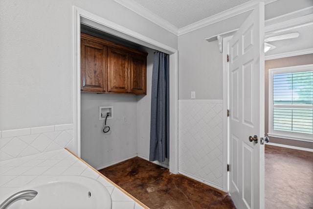 bathroom with crown molding, sink, a textured ceiling, and a washtub