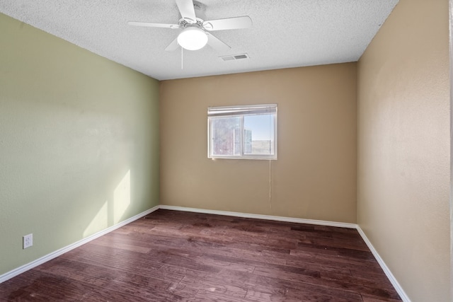 empty room featuring ceiling fan, wood-type flooring, and a textured ceiling