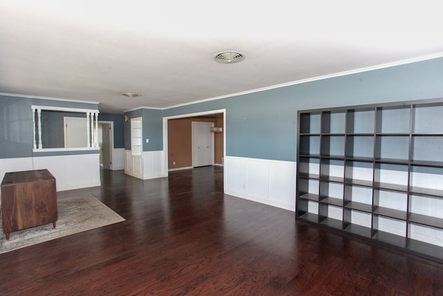 1706 Harvard Ave, Big Spring, TX 79720 - unfurnished living room with crown molding, wainscoting, wood finished floors, and a decorative wall