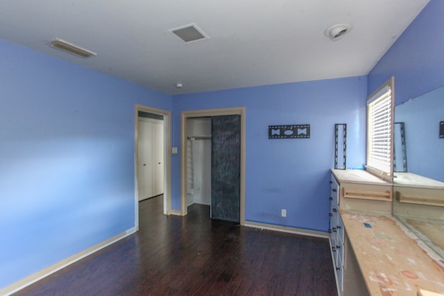 1706 Harvard Ave, Big Spring, TX 79720 - unfurnished bedroom with wood finished floors, baseboards, and a closet