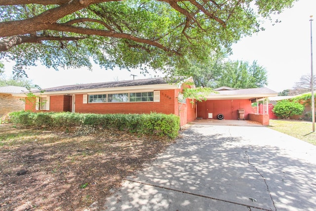 1706 Harvard Ave, Big Spring, TX 79720 - ranch-style home featuring driveway, an attached carport, and brick siding