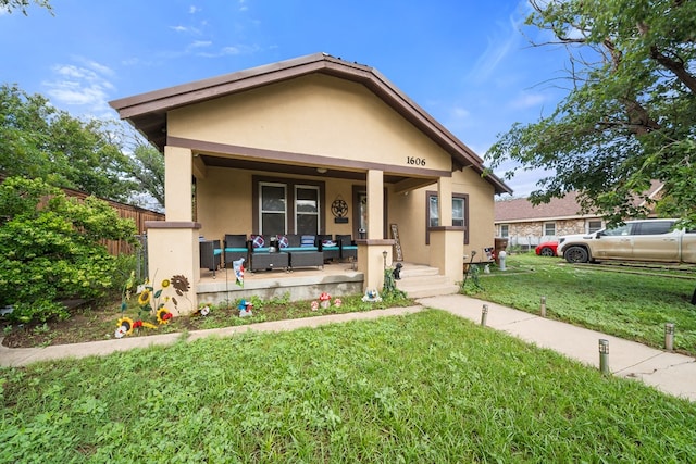 1606 Johnson St, Big Spring, TX 79720 - bungalow-style home with an outdoor hangout area, stucco siding, and covered porch