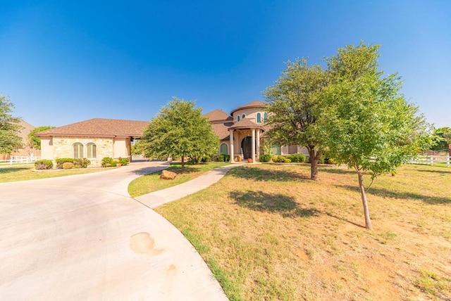 mediterranean / spanish-style house featuring a front yard