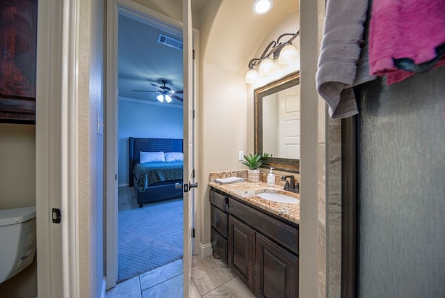 bathroom with vanity, tile patterned floors, crown molding, ceiling fan, and toilet