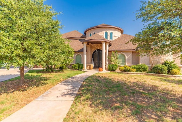 mediterranean / spanish-style home featuring a front yard