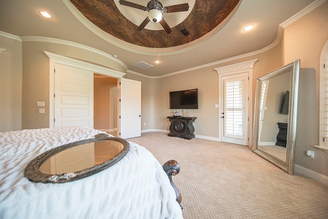 bedroom featuring ceiling fan, light colored carpet, crown molding, and a tray ceiling