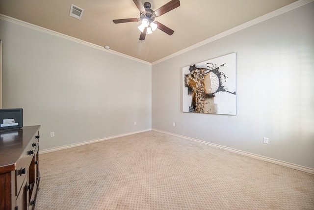 carpeted spare room featuring ceiling fan and crown molding