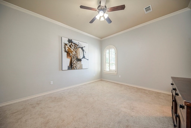 unfurnished room featuring light colored carpet, ceiling fan, and crown molding