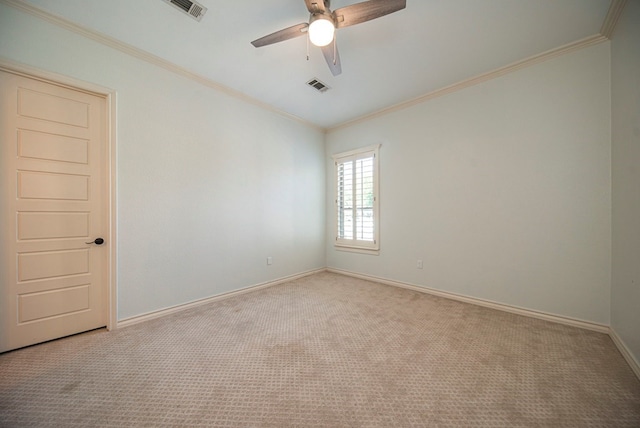 carpeted spare room featuring ceiling fan and crown molding