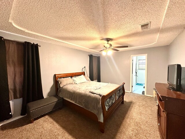 2204 Regal Pl, Midland, TX 79707 - carpeted bedroom with a textured ceiling, ceiling fan, and ensuite bath