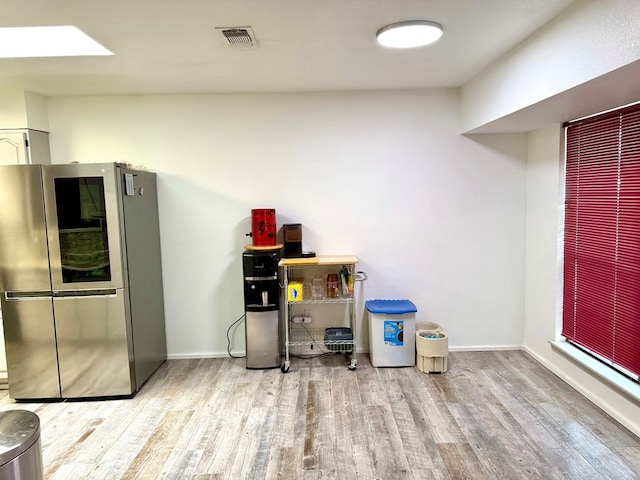 2204 Regal Pl, Midland, TX 79707 - kitchen featuring smart refrigerator, wood finished floors, baseboards, and a skylight