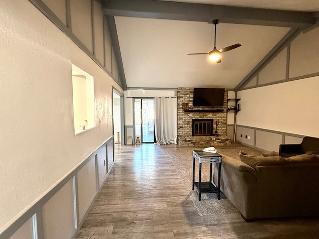 2204 Regal Pl, Midland, TX 79707 - living area featuring a fireplace, high vaulted ceiling, beamed ceiling, a ceiling fan, and wood finished floors