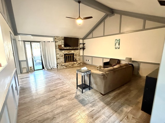 2204 Regal Pl, Midland, TX 79707 - living area featuring ceiling fan, beamed ceiling, a brick fireplace, wood finished floors, and high vaulted ceiling
