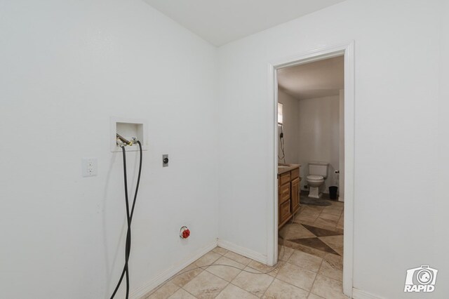 washroom featuring hookup for an electric dryer, washer hookup, and light tile patterned floors