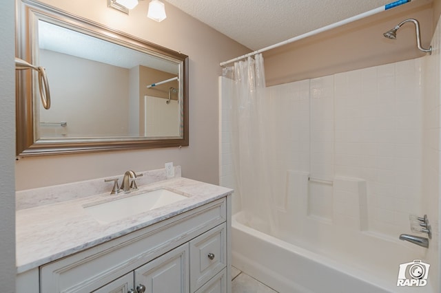 bathroom featuring vanity, shower / bath combo with shower curtain, and a textured ceiling