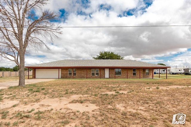 ranch-style house with a garage and a front yard